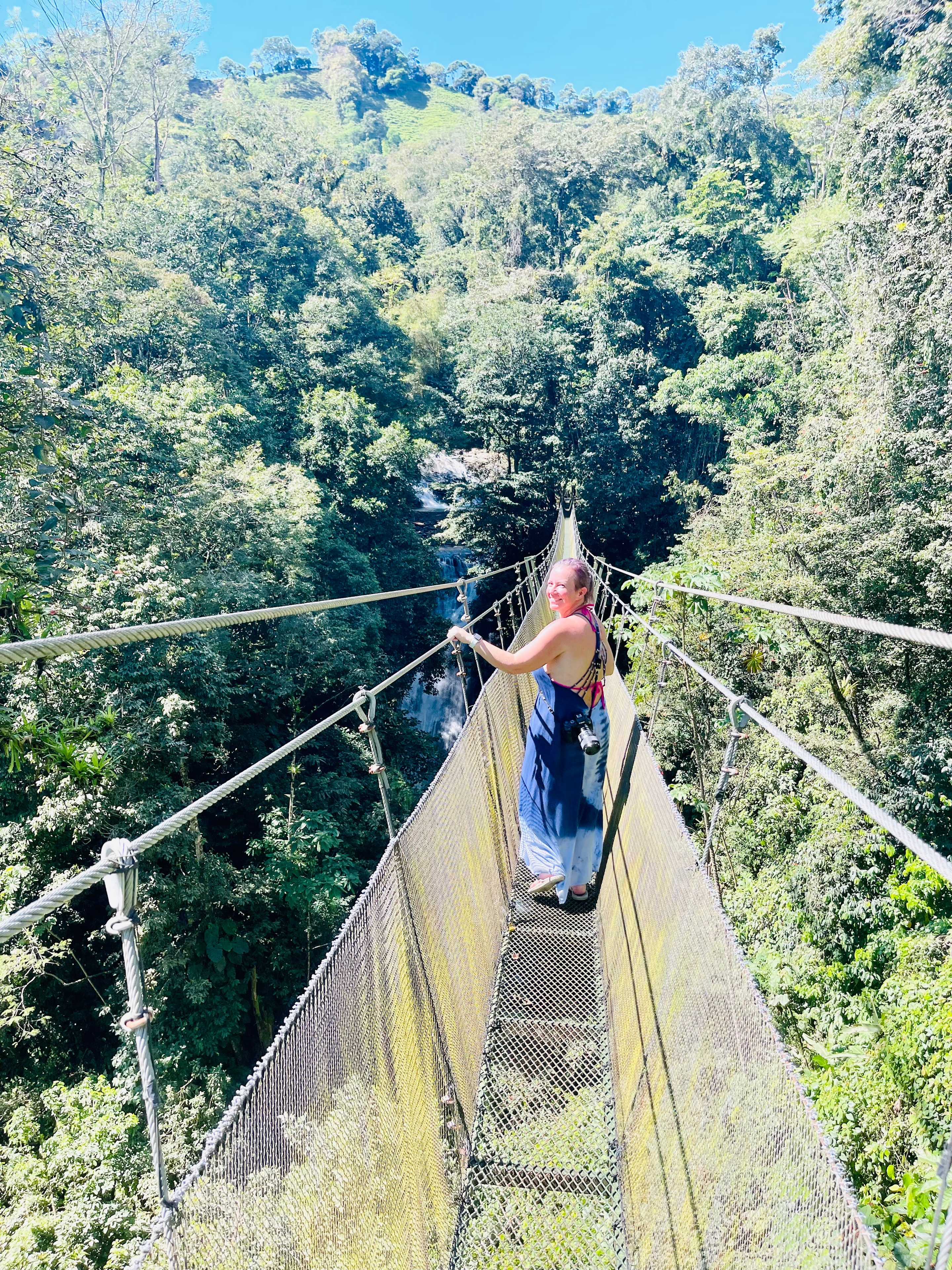 Suspension bridge through lush Costa Rica rainforest canopy