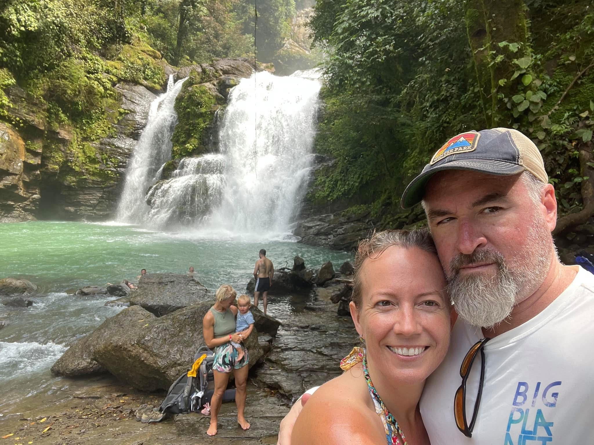 Group at a stunning waterfall in the Costa Rica rainforest
